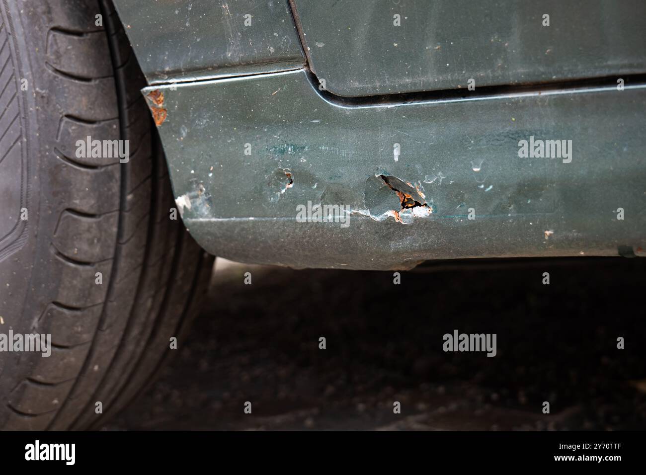 Rusty car body sill with through hole. Close up shot, no people. Stock Photo