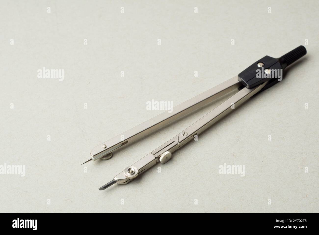 Compass on a white background. Drawing tools. Close-up. copy space Stock Photo