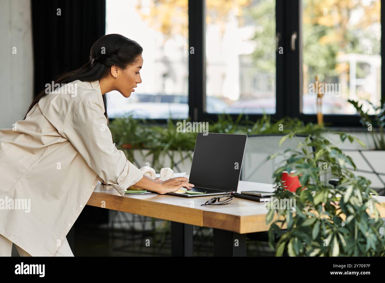 Young businesswoman leans over desk hi-res stock photography and images ...