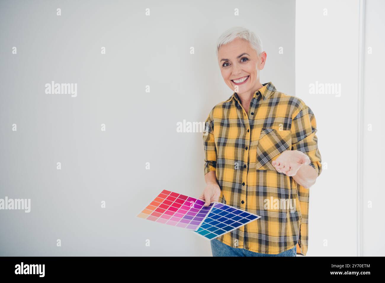 Photo of nice aged woman hold color palette papers show wall paint ...