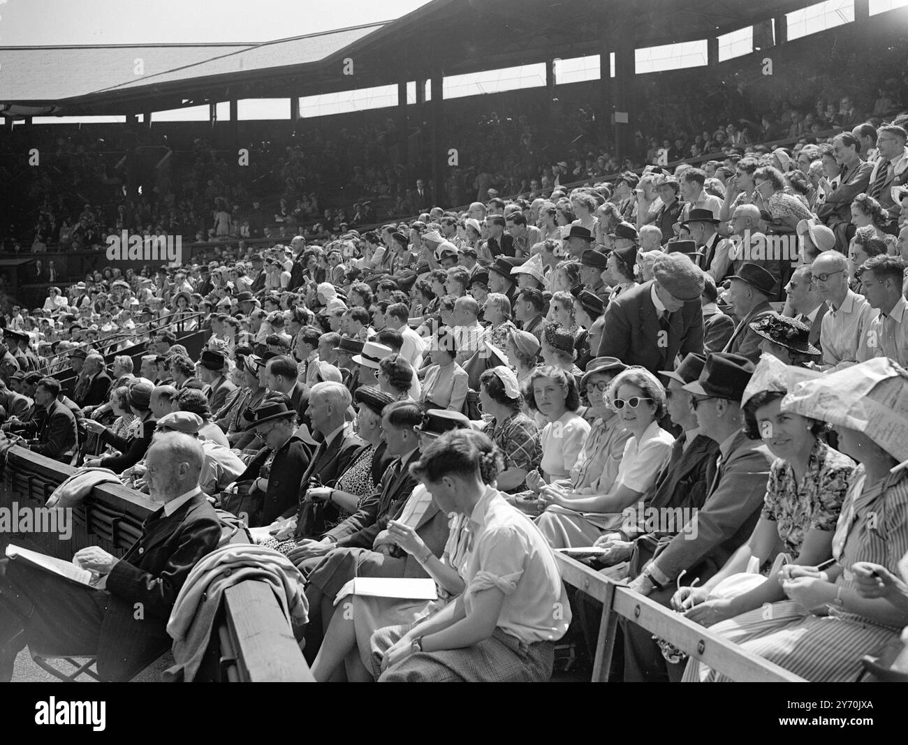 CENTRE COURT CROWD AT WIMBLEDON    Crowd scene on the Centre Court at the All - England Club , Wimbledon ( London ) , as R . FALKENBURG of U.S.A . MET d. Mitic  of Yugoslavia in the first Centre Court match of this year's Wimbledon tennis championship .Falkenburg is holder of the men's single title .    June 20 1949 Stock Photo