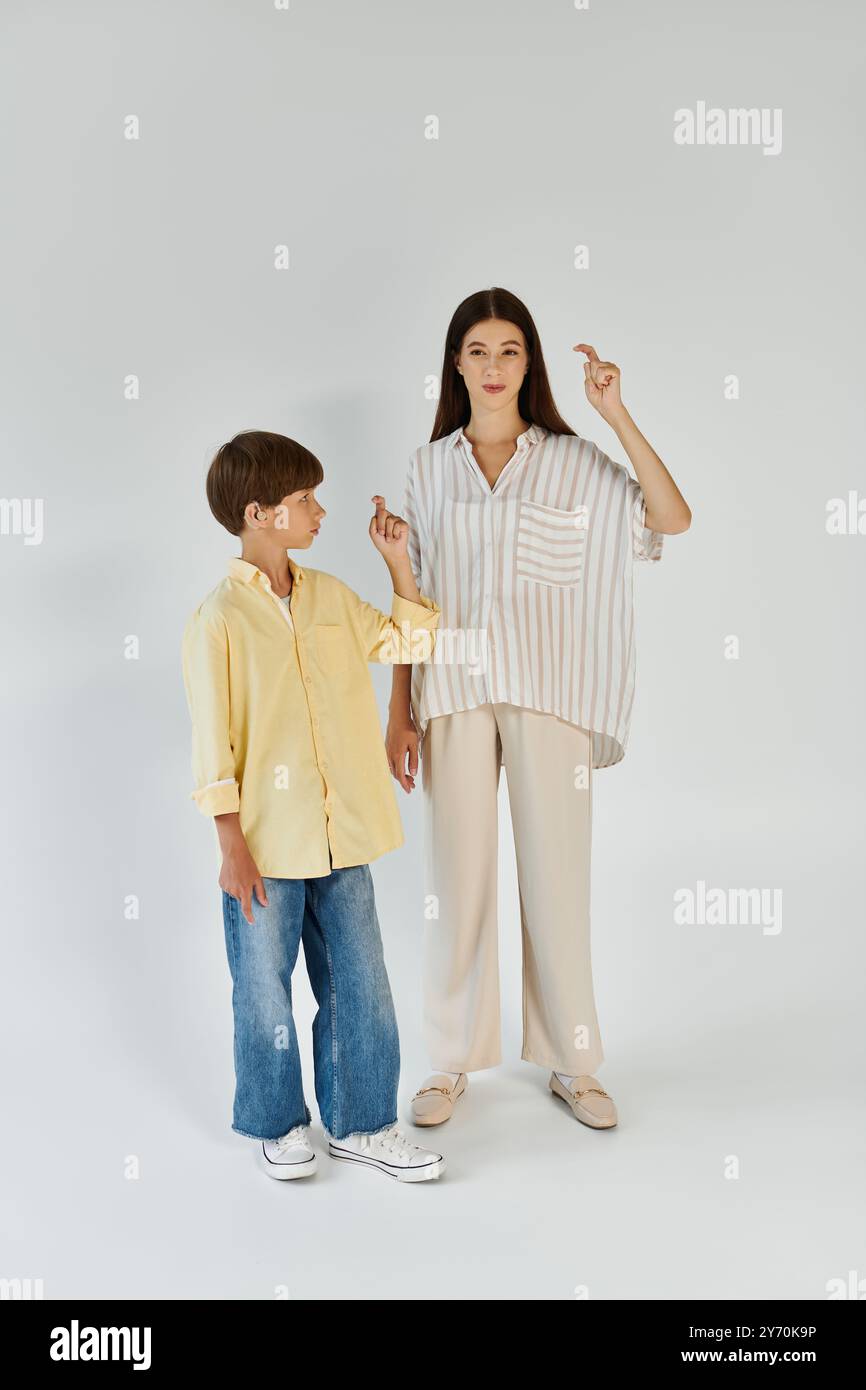 A mother and her son express themselves through sign language in a warm ...