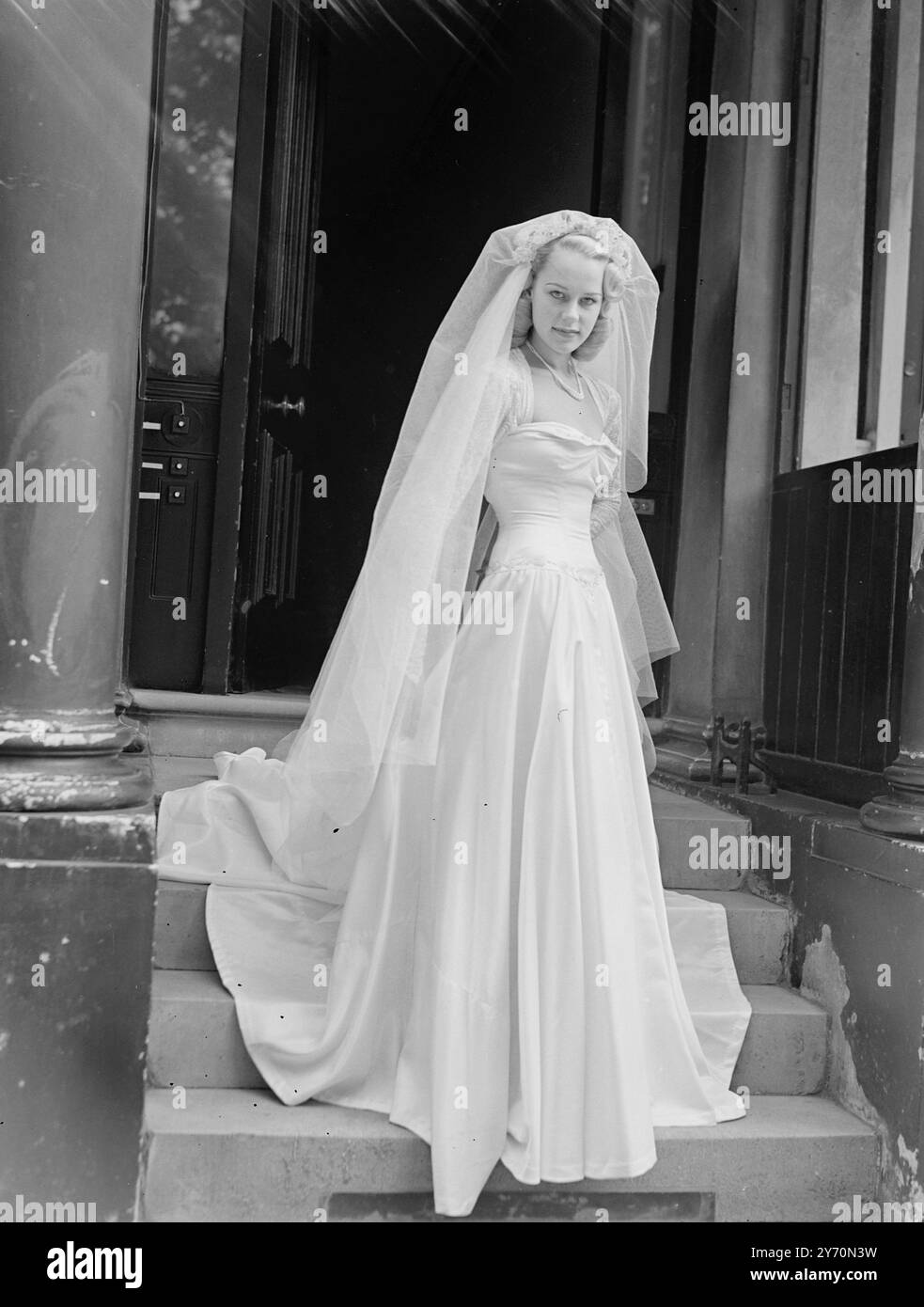 MOTHER MADE PATTI'S WEDDING DRESS   Wearing a wedding gown made her by her mother 20-year-old Patty Morgan, Australian actress, who tomorrow is to become the bride of Mr. Victor Sylvester, son of Victor Sylvester, the dance band leader and teacher of dancing, at St Mark's Church, North Audley Street, London.  The gown is of white slipper satin, Ms Morgan says that all her clothes are made by her mother- Miss. Irene  Morgan, from Sydney, Australia.  The bride-to-be was one of Australia's most popular camera models before she came to Britain in 1946.she made her screen debut in ' Idol of Paris ' Stock Photo