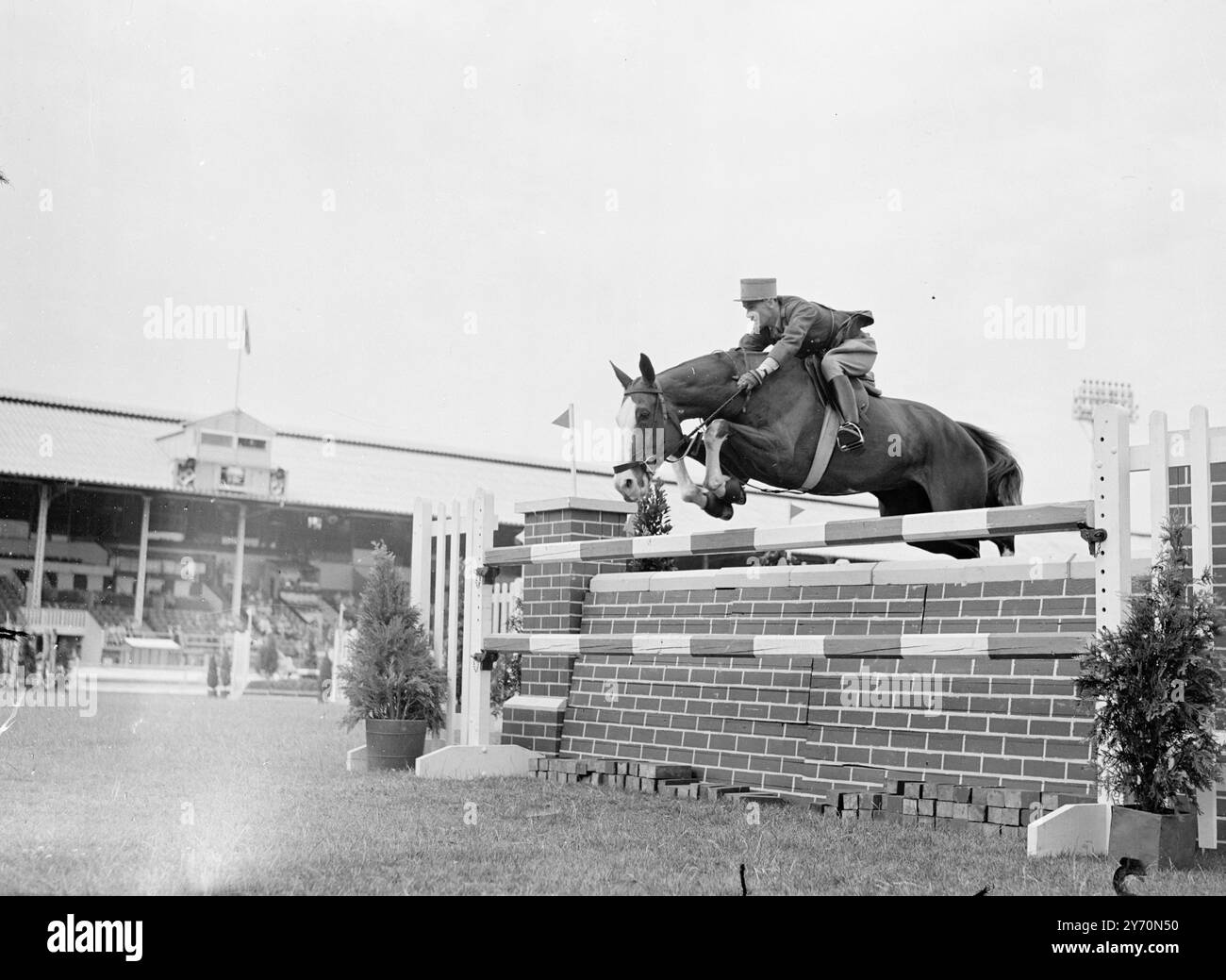 FRENCH COMPETITOR AT LONDON HORSE SHOW   ' BEL OISEAU ,' French entry ridden by Capitaine FRESSON , takes a jump in the ' Country Life ' and riding competition at the International Horse Show at the White City , London .  July 21 1949 Stock Photo