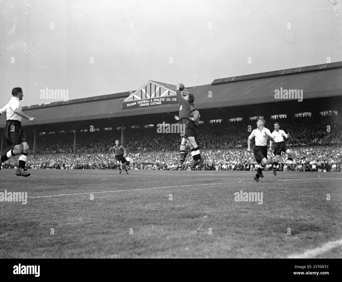 THEY START WITH A SAVE   Proud moment for Fulham supporters as goalkeeper Flack , makes a fine save frominside left says DUNN , of Wolves , at Craven Cottage this afternoon when the London team made their first-ever appearance in Division One . Added attraction of the match was that their opponents were the Cup holders , Wolverhampton Wanderers .     21 August 1949 Stock Photo