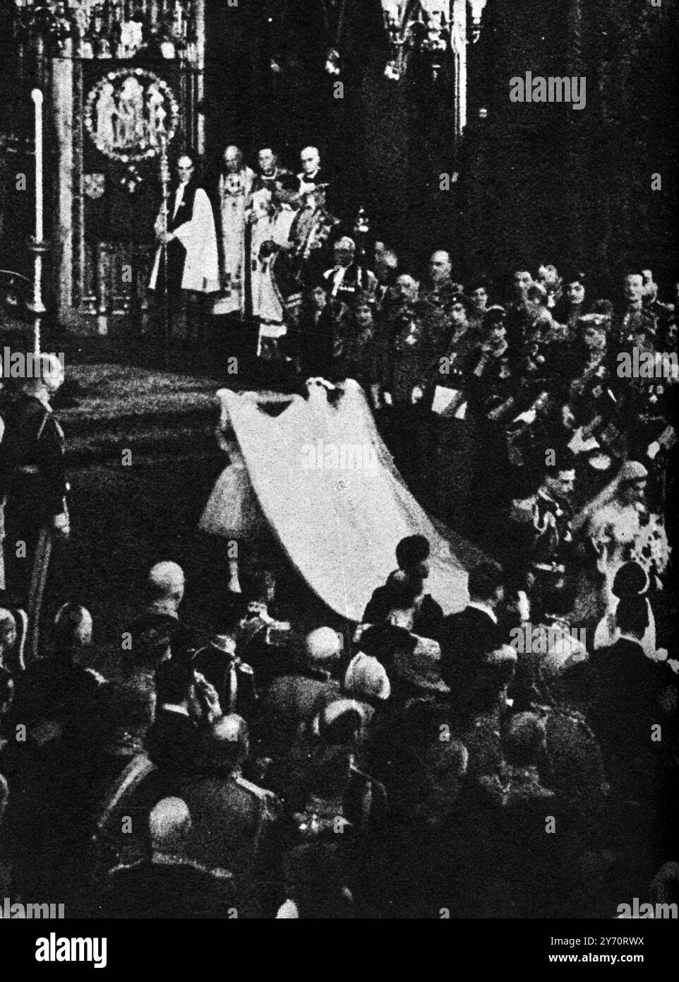 The Royal Wedding : Details of the Westminster Abbey Ceremony of the Duke of Kent and Princess Marina of Greece 29 November 1934 . Seen here the two young bridesmaids , Princess Elizabeth and Lady Mary Cambridge , holding high the brides train , during the procesion from the altar , London , England . 1 December 1934 Stock Photo