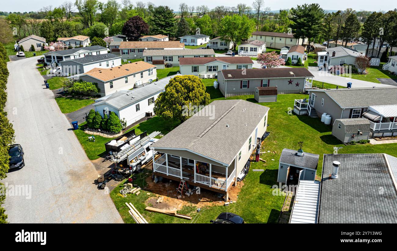Aerial view shows mobile, manufactured homes lined along a tranquil ...