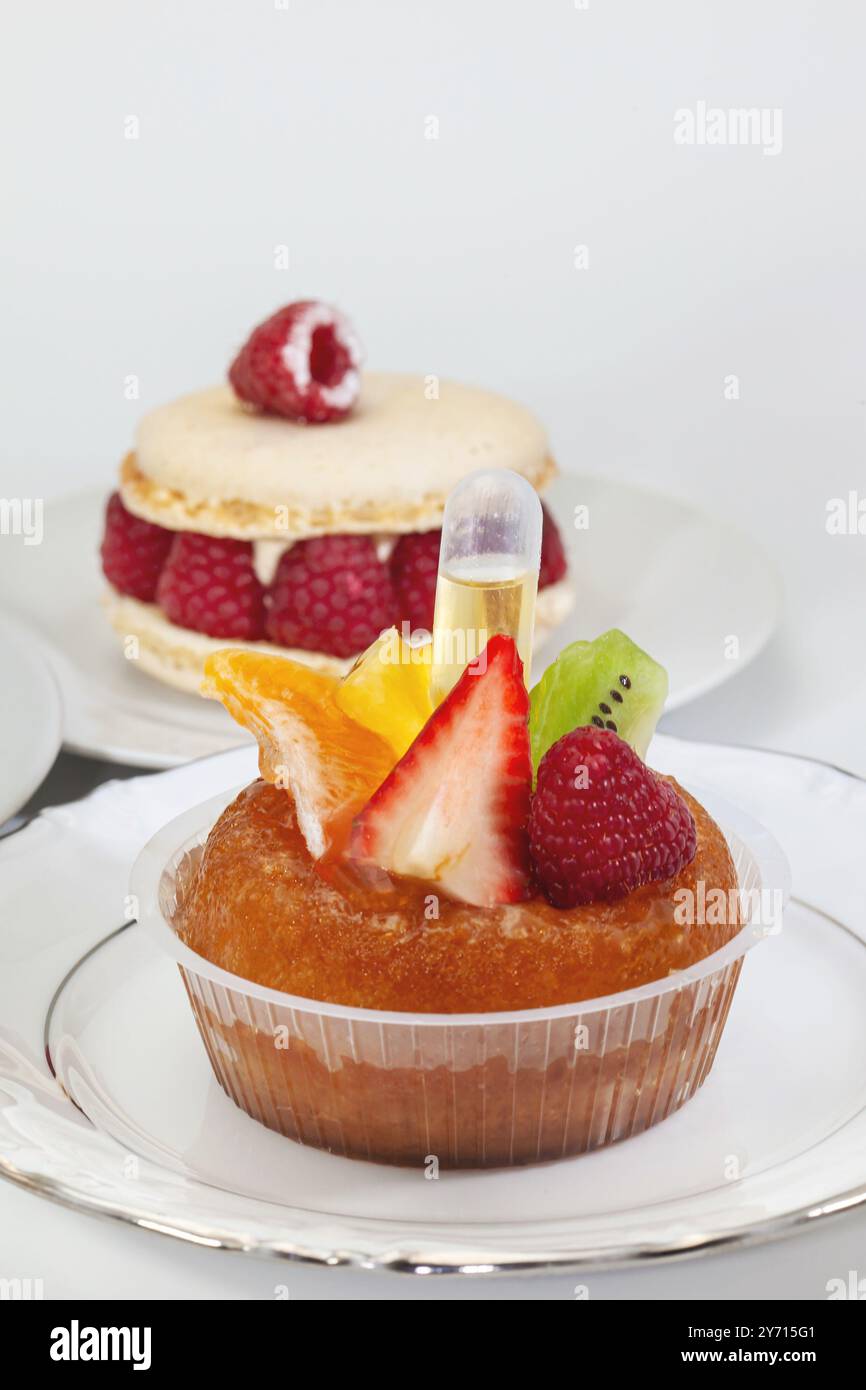 Classic French rum baba and fresh fruits Stock Photo - Alamy