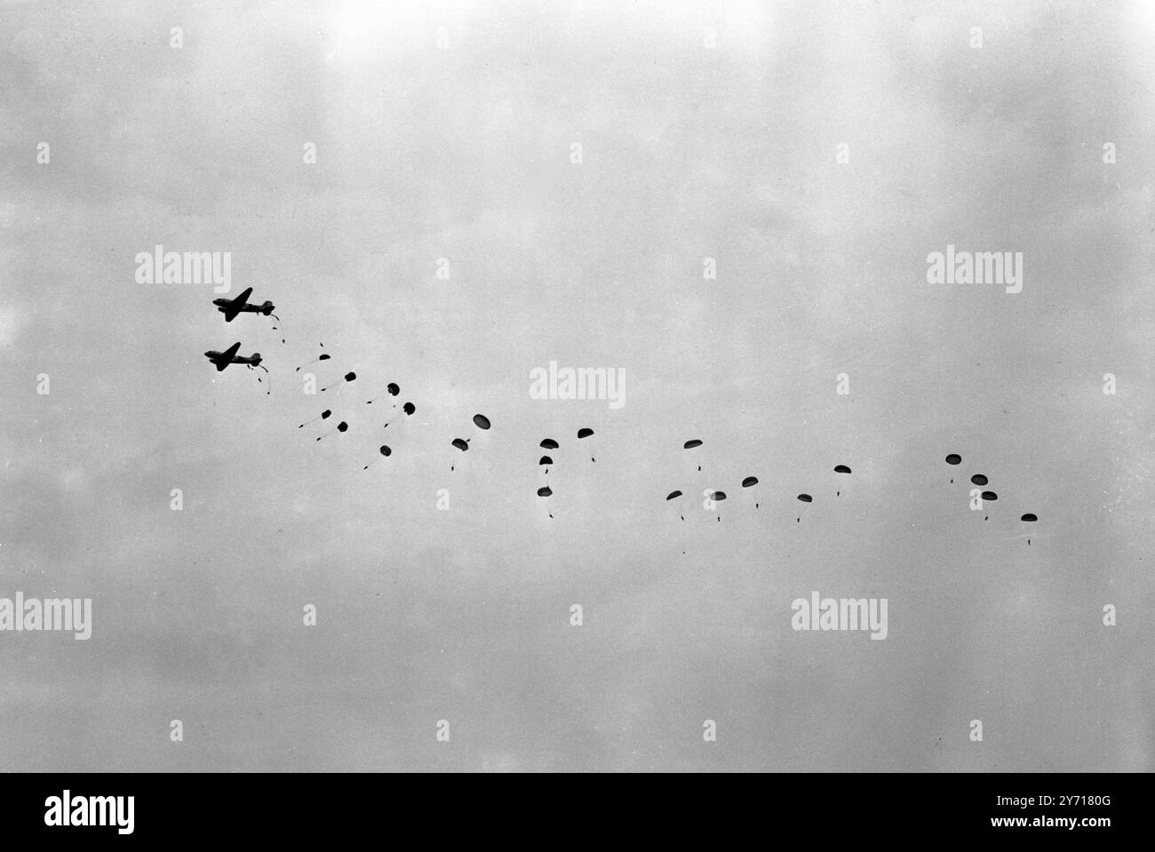 At the demonstration held at Netheravon on Salisbury Plain by the School of Land / Air Warfare No6 Special Course , one of the highlights was the dropping of the Universal Container , by which large freight may be carried by parachute . Seen here troops dropping by parachute from two transport carrier planes during the manoeuvres yesterday . 28 October 1948 Stock Photo