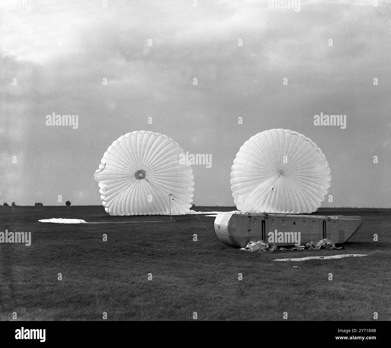 At the demonstration held at Netheravon on Salisbury Plain by the School of Land / Air Warfare No6 Special Course , one of the highlights was the dropping of the Universal Container , by which large freight may be carried by parachute . Seen here one of the Universal Containers , in which there is a jeep and trailer , on the ground with parachutes still attached , after being dropped by a Halifax . 28 October 1948 Stock Photo