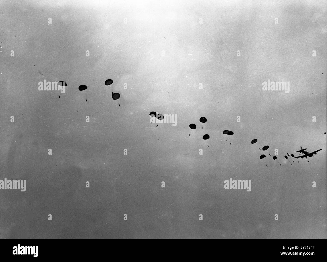 At the demonstration held at Netheravon on Salisbury Plain by the School of Land / Air Warfare No6 Special Course , one of the highlights was the dropping of the Universal Container , by which large freight may be carried by parachute . Seen here troops dropping by parachute from two transport carrier planes during the manoeuvres yesterday . 28 October 1948 Stock Photo