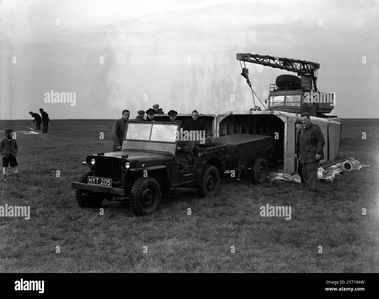 At the demonstration held at Netheravon on Salisbury Plain by the School of Land / Air Warfare No6 Special Course , one of the highlights was the dropping of the Universal Container , by which large freight may be carried by parachute . Seen here a jeep and trailer being unloaded from the Universal Container , which has just been dropped from a Halifax . 28 October 1948 Stock Photo