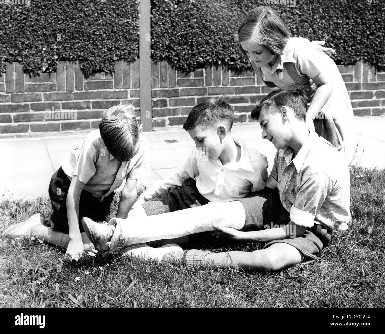 David Read , aged 13, of Harland Avenue , Sidcup , Kent , is very proud of his injured leg. He injured it playing cricket , and recently , while watching Douglas Wright and Jack Martin , the Kent and England cricketeres , he asked these players to sign their autgroaph on his plaster cast leg .  Now David's leg is a source of pride and wonderment to the rest of the boys and girls in his street .  10 July 1950 Stock Photo