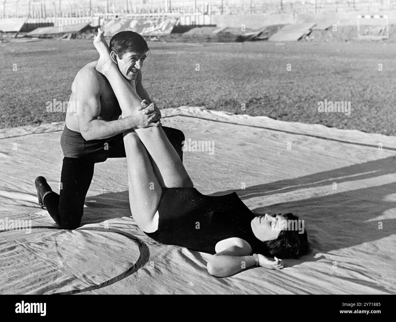 This Young Lady Tries Out A Leg Scissors On A Man Wrestler As She 