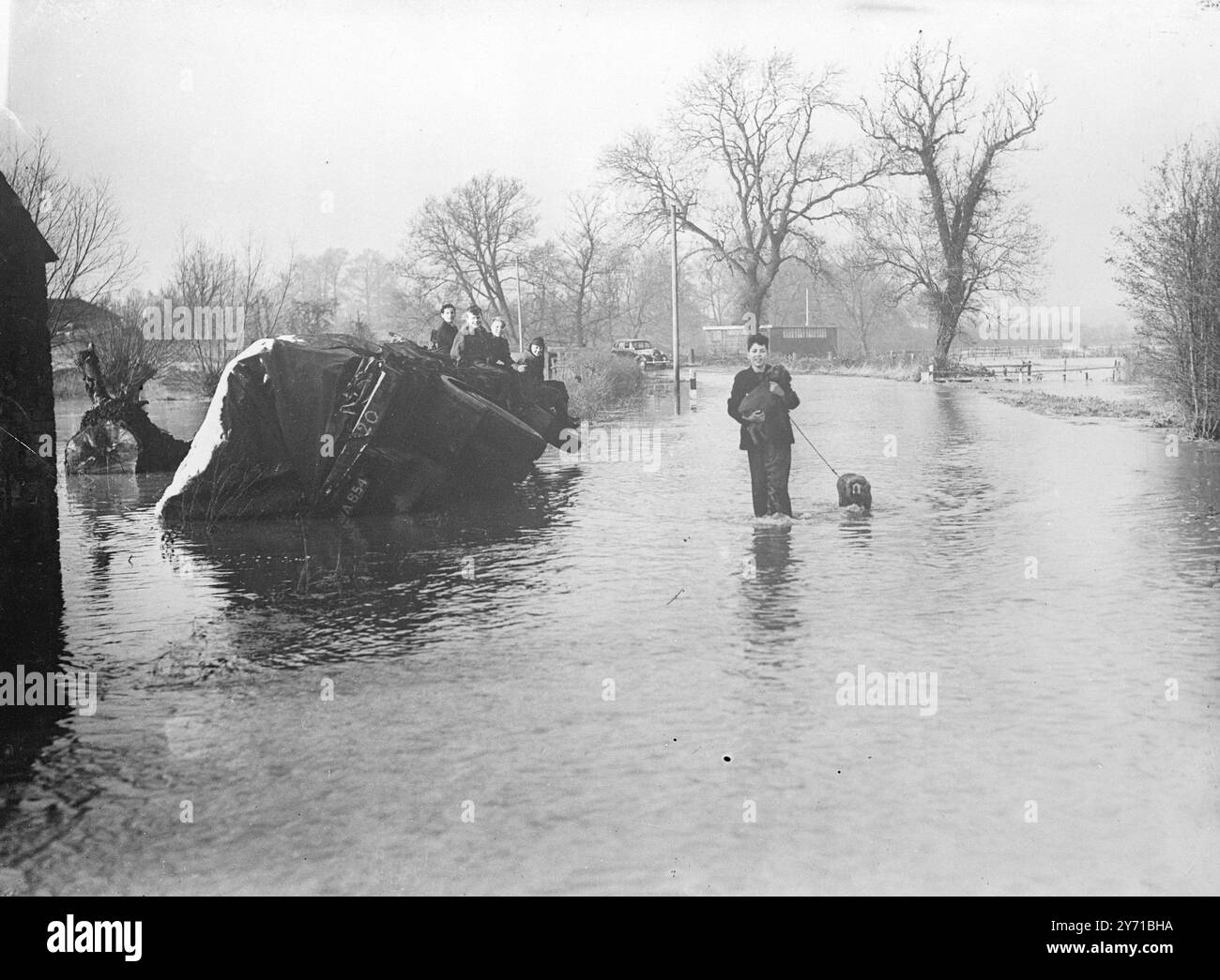 LEICESTERSHIRE HIT BY FLOODS   Leicester had 1.54 inches of rain in Thursday's torrential downpour- equal to the total rainfall for the month November . Firemen spent hours pumping water from four factories and draining water from a number of houses in Eastwood Road, Leicester. Red signs warned traffic from Aylestone and Leicester they could not get through . One of the worst parts to be affected by the floods was at Asfordby where new council houses were inundated , and tenants had to spend the night with relatives .     PICTURE SHOWS:- FRANK BOTT , of Cossington , wades through the floods at Stock Photo
