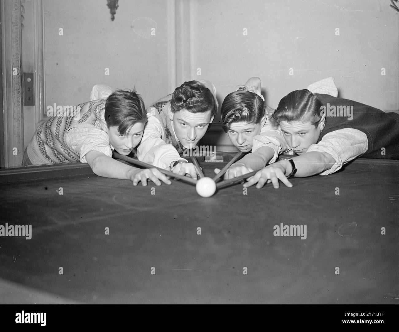 MINERS HOPES FOR BILLIARDS CHAMPIONSHIP   Left to right:- COLIN SMITH of CROOK , CO. DURHAM , IVAN CHEETHAM of CHASE TERRACE , WALSALL , ALAN JOHNSON of BOLDON COLLIERY, COUNTY DURHAM AND JOHN SINCLAIR of ASHINGTON , NORTHUMBERLAND , photographed at the Boys Billiards Championships which opened at Burwat Hall , Soho Square , London. They are all miners son's . The championship is in aid of St. Dunstan's Fund for the Blind .     28 December 1948 Stock Photo