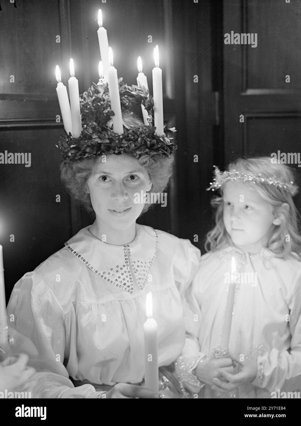 CROWNING LONDON's QUEEN OF LIGHT28-year-old ELLEN BERGSTROM, an organist at the Swedish Church in Harcourt Street, London, was crowned there today (Monday), as SAINTA LUCIA. The ceremony coincided with those in Sweden in celebration of the 'Return of The Light”, for in olden days it was believed that after this day the nights grew shorter. it also commemorates the martyrdom of St. Lucia who was killed over 1,900 years ago. After her religious beliefs had been revealed by her lover attempts were made to burn her, but without success, so she was killed with the sword. Her ability to withstand th Stock Photo