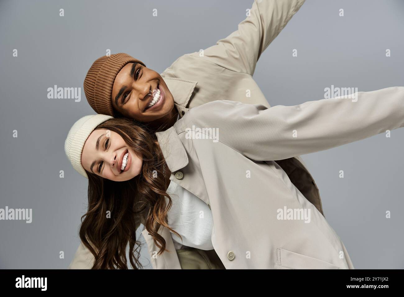 Dressed in stylish autumn attire, a young couple radiates happiness ...