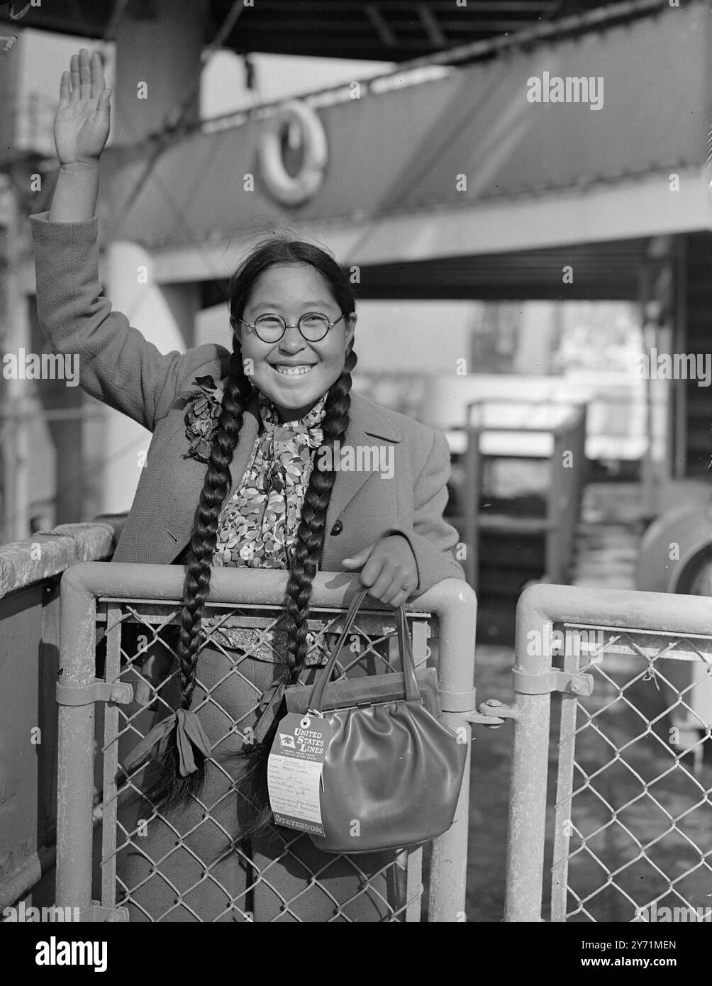 Original caption: ESKIMO GIRL LEAVES   FOR HOME .     Fifteen year-old REBECCA , the Eskimo girl from Baffin hand , who has been living in this country since last December , has decided that England is  too warm  a place , and is now returning to her native land .     PICTURE SHOWS :-  ' It ' s too hot for me '   REBECCA , the eskimo girl , waves a cheerful good bye to the country she found too warm , She left on the United States ship  ' Marine Jumper ' , last night .     June 4 1948 Stock Photo