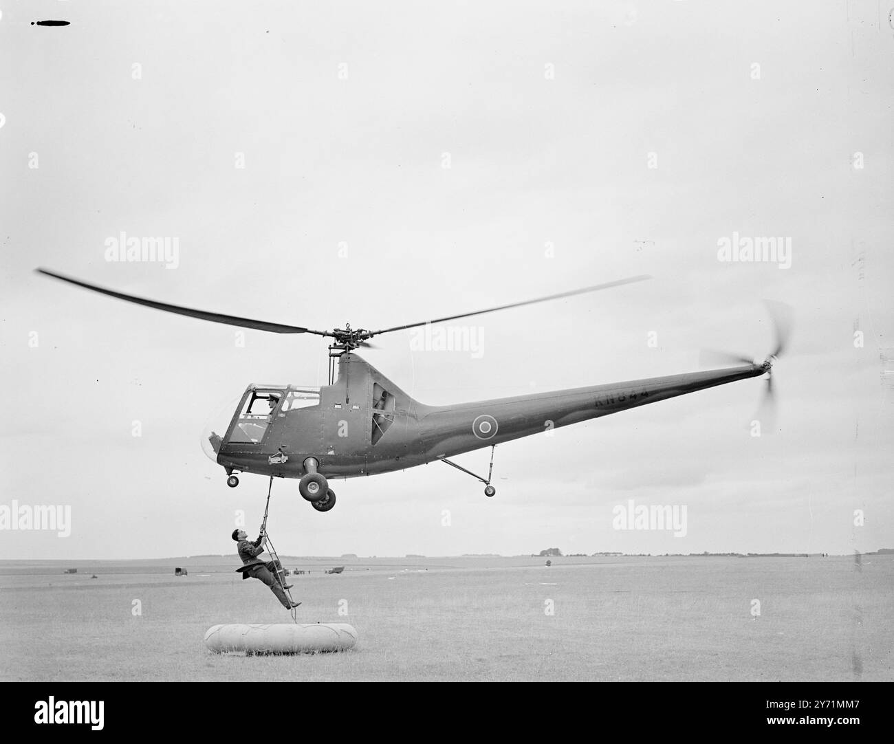 RAF EXCERCISE AT SALISBURY.    The R A F held a land/ air exercise at Netheravon Airfield , Sailisbury . Among the aircraft employed in the excercise wre spitfires , Halifaxes , Dakota ' s and gliders .     PICTURE SHOWS :- ' To the rescue '  A Hoverfly Helicopter comes down to rescue the stranded man in a rubber dinghy , during an R A F  Exercise .     June 4 1948 Stock Photo