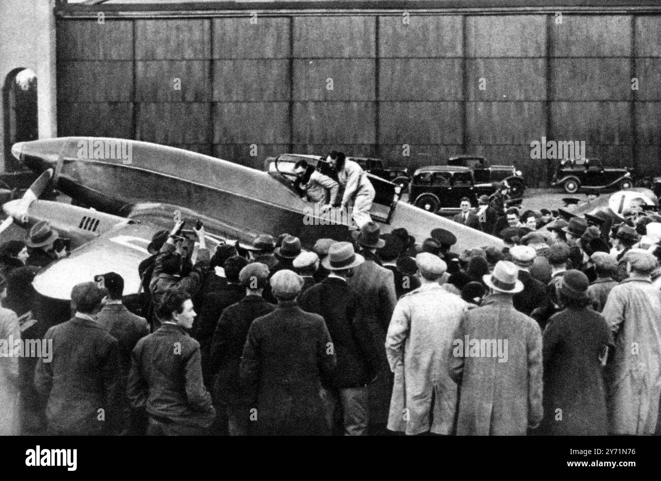 To Melbourne and back in less than a fortnight : Mr Cathcart Jones and Mr Ken Waller clambering from their DH Comet at Lympne , Kent , England . 10 November 1934 Stock Photo