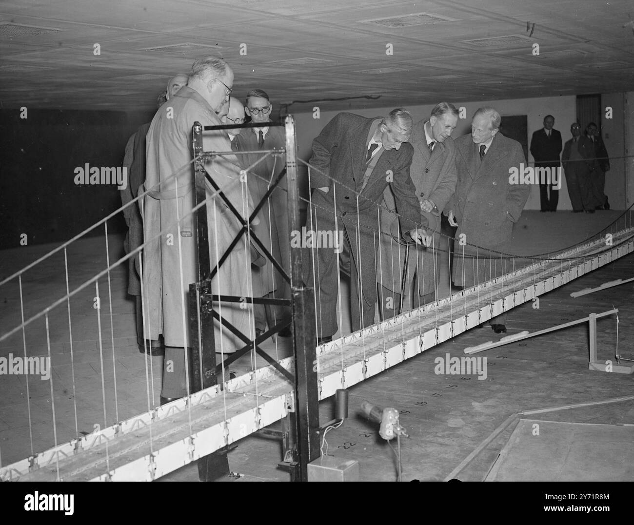 SEVERN BRIDGE WIND-TUNNEL TESTS   Mr . Alfred Barnes , Minister of Transport impacted the specially designed wind-tunnel erected at Thurleigh (Beds)  in which experiments are to be carried out as part of the investigation into the behaviour of suspension bridges when exposed to wind action .   The results of the experiments will determine the final design of the proposed Severn Bridge , which when completed will be the largest suspension bridge in Europe .    PICTURE SHOWS; Right to Left:  Sir Ralph Freeman , one of the consulting bridge engineers and designer of the famous Sydney Harbour Brid Stock Photo