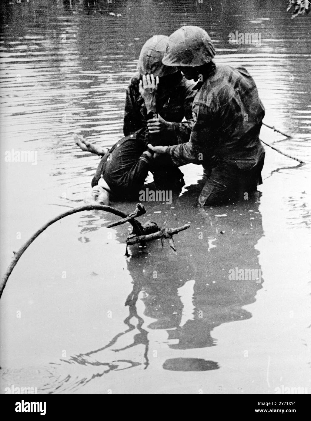 'Ducked for Information'    Bac Quanh, South Vietnam : Vietnamese marines submerged the head of a Viet Cong prisoner as they attempt to interrogate him after capturing several of the guerillas in an operation on March 25. 27 March 1965 Stock Photo