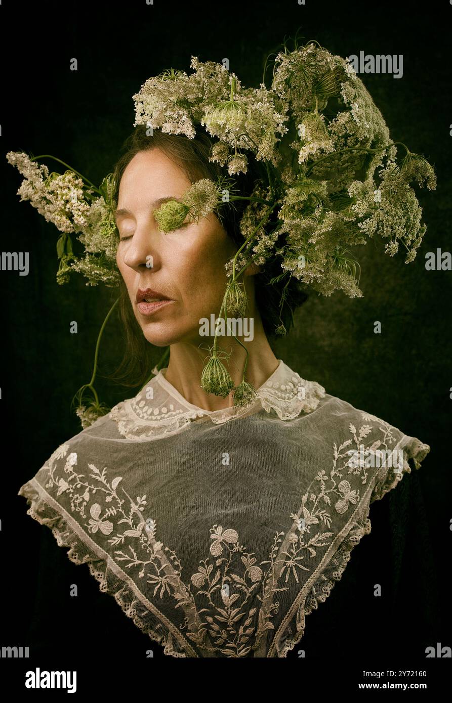 woman with bouquet of cow parsley on her head in romantic attitude XI, spain Stock Photo