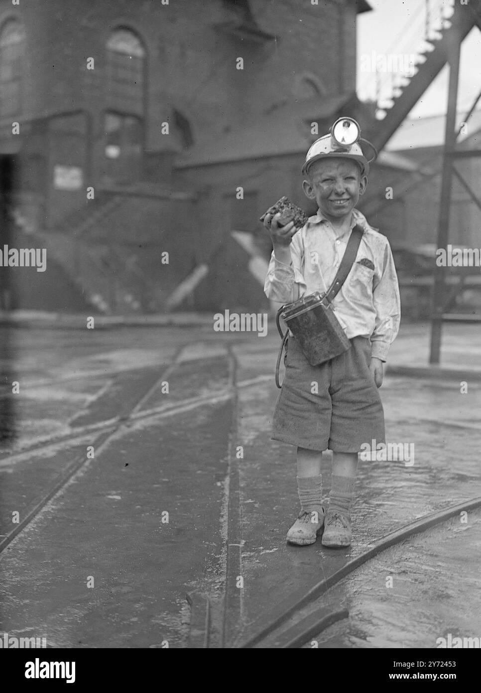 One of five boy finalists in an essay competition dealing with Coal, is 12 year old, 3ft 10 inch Brian Drewberry of Thirds, he was given a tour of the coalfields as guest of the national coal board. Brian, complete with miner's helmet, descended the pit at Astley Green colliery, near Manchester, and out himself a 'large lump' of coal. - - Picture shows: 'all my own work'-'half pint' Brian Drew Berry looks as black as any of his grown-up counterparts as complete with lamp and helmet he holds up a lump of coal. - - - - - - 1st April 1948 Stock Photo