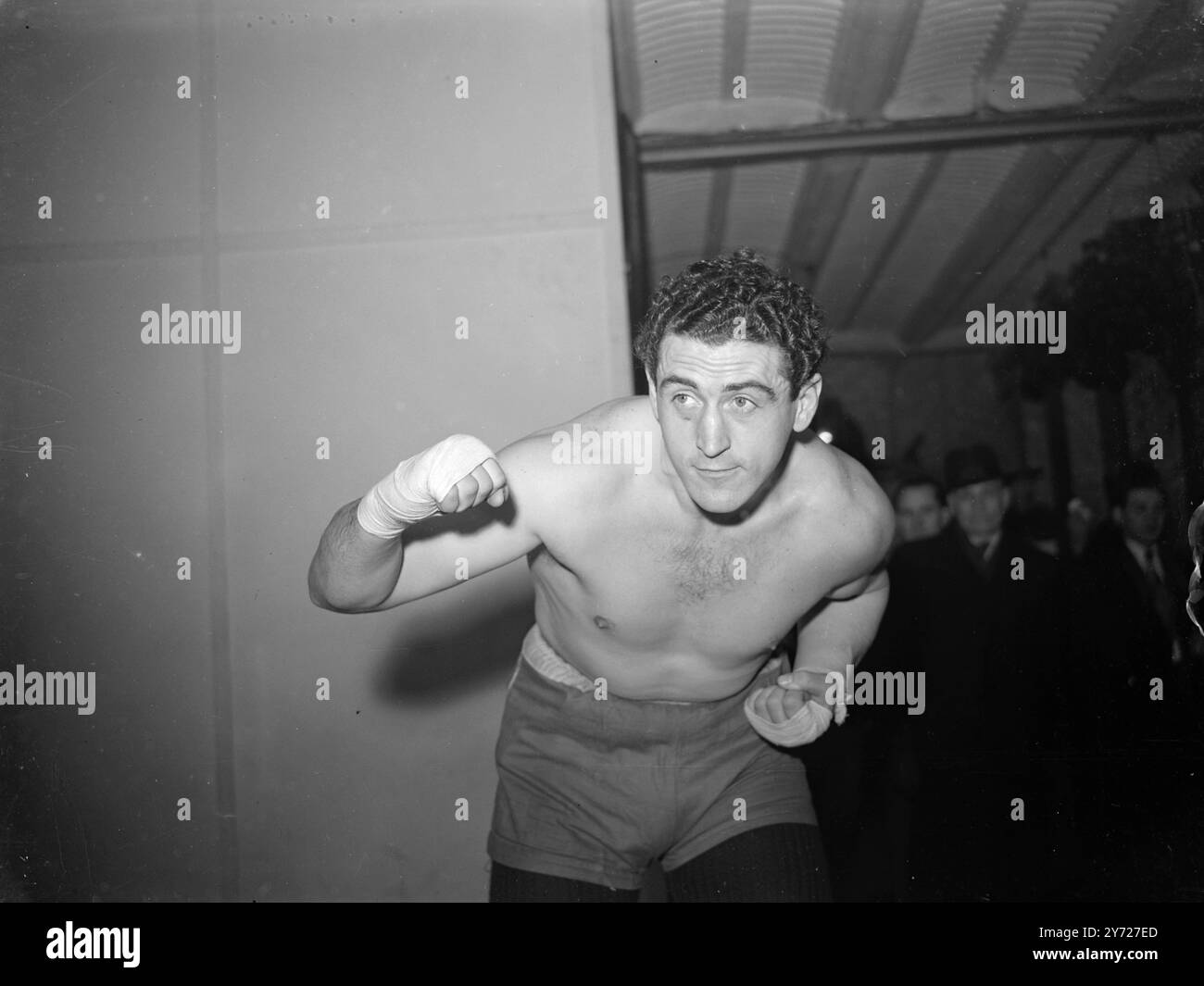 Another Champion Joe.   London has another heavyweight champion. Joe as a guest today (Thursday) in the person of Austrian heavyweight Joe Weidin who is to meet Alf Brown (Catford) at the Albert Hall on March 1st.  Picture Shows: 'Brown Bomber' Heavyweight champion of Austria, Joe Weidin trains to 'Bomb' Alf Brown at Jack Solomans gym today (Thursday).    26 February 1948 Stock Photo