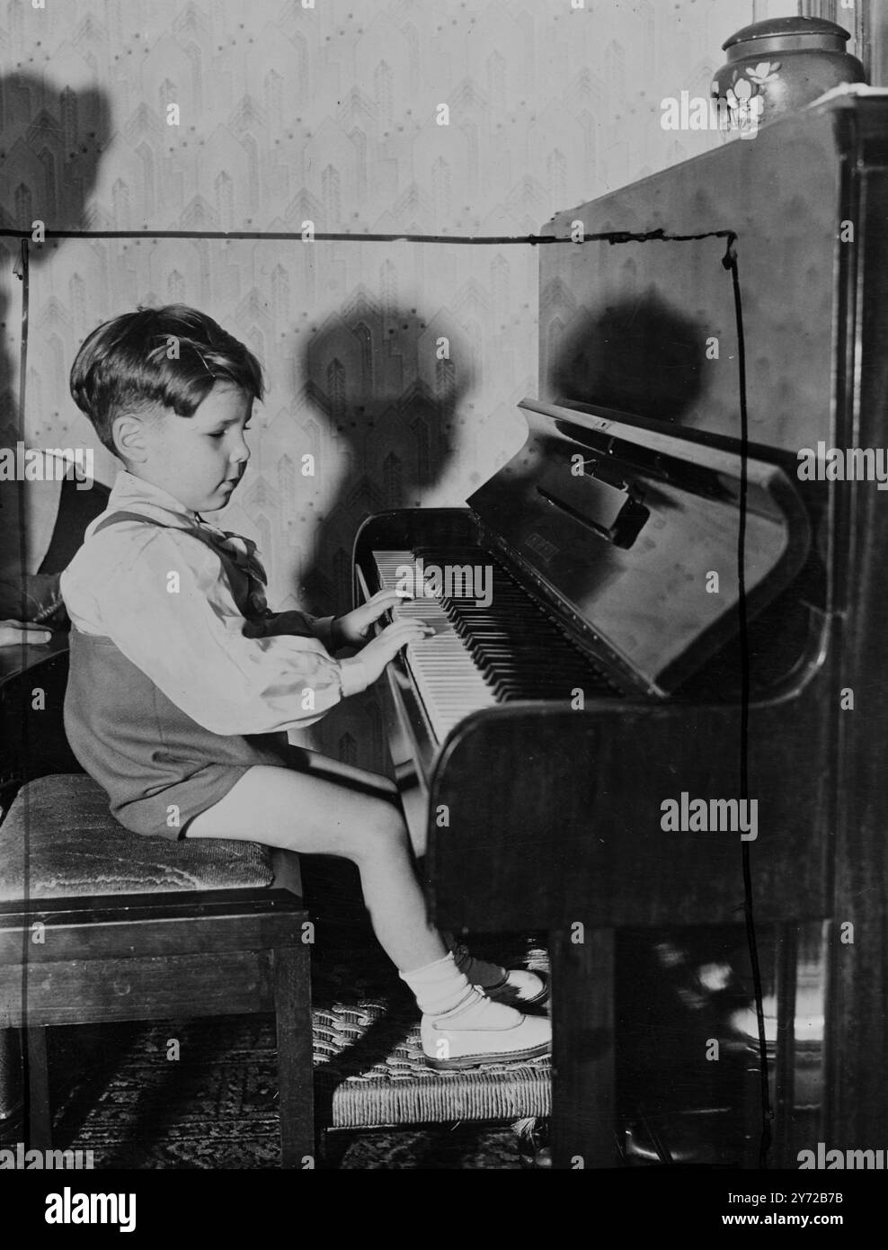 Blind boy is pianist at three. Legal and child welfare experts are to be consulted to see with a blind three-year-old Bristol boy, Paul Peacock, who is shown phenomenal musical prowess, may be allowed to appear at public performances. Anxious to launch him on a concert career of the boys and girls of the Bedminster Odeon, Bristol, Cinema Club. Paul, whose father is a fitter at a local engineering works, has never had any instruction in music. Blind from birth, listens to the radio, he is a true and he likes, then goes to an organ in the next room and plays it. Today at a neighbours piano, some Stock Photo