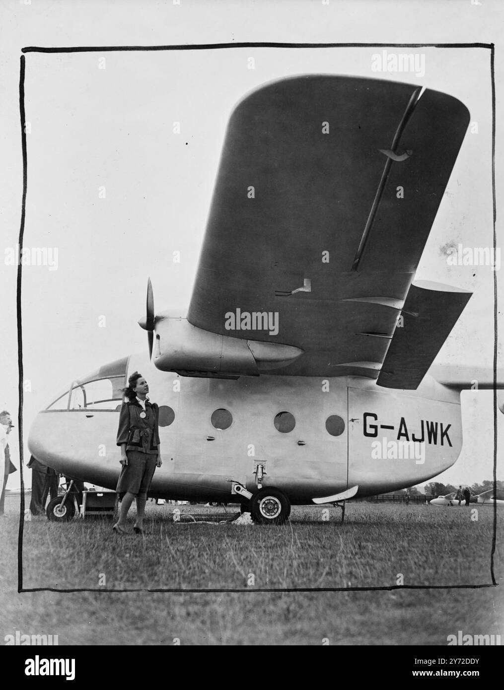 World's greatest air show will boost British exports. 6000 guests from all over the world are attending the world's greatest aircraft exhibition and fly display which opened today at the Handley Page Aerodrome at Radlett, Herts. Over 70 different aircraft, ranging from giant airliners, jet propelled military aircraft and private owner planes to gliders, there to attract the foreign buyers. The show is organised by the Society of British Aircraft Constructors.  Photo shows, Miss E Shanks, a visitor to the airshow, taking a look at a Miles Aerovan, one of Britain's newest air freighters.  9 Sept Stock Photo