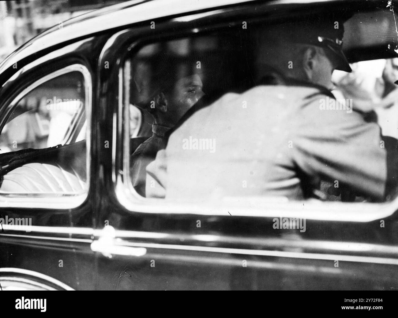 Frederick Alfred Smith, 21-year-old window cleaner, of Surrey, was charged at Guildford with murdering nine-year-old Lesley Gaff and his sister Eileen aged 7. Picture shows : Frederick Smith pictured in a police car at Guildford today.  28 July 1947 Stock Photo