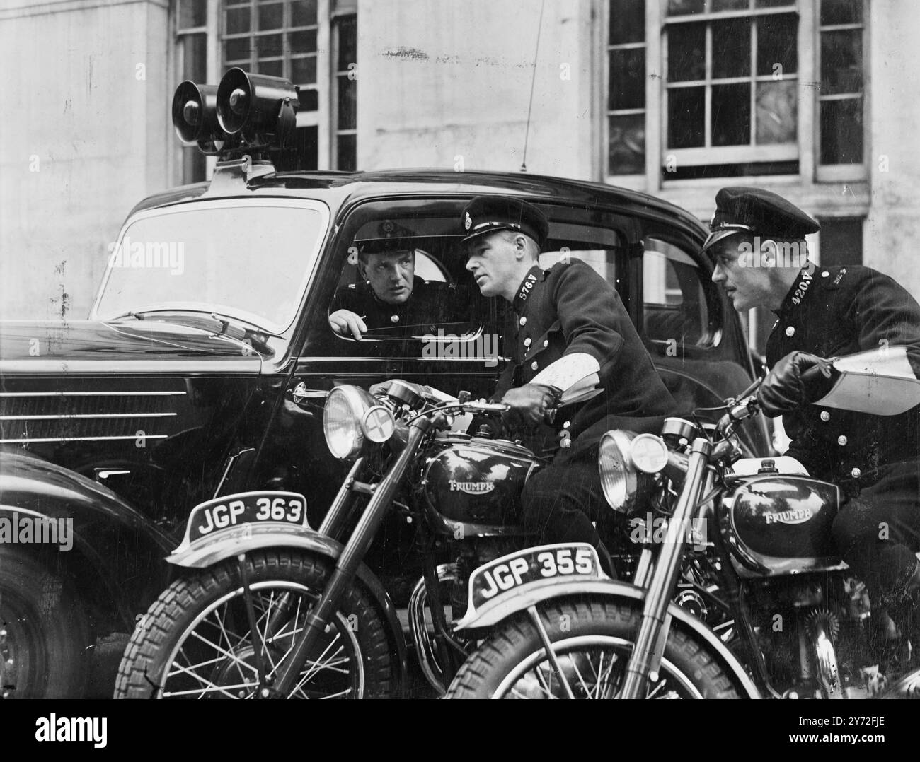 The first of a number of radio controlled police cars, with attendance motorcyclists, for use in the rapid investigation of road accidents and traffic congestion within the metropolitan area demonstrated at Scotland Yard today. Photo shows: the message has been flashed by R/T to the car. Verbal instructions are given to the motorcyclists to proceed to the scene of the incident. A picture from this morning's demonstration.  24 July 1947 Stock Photo