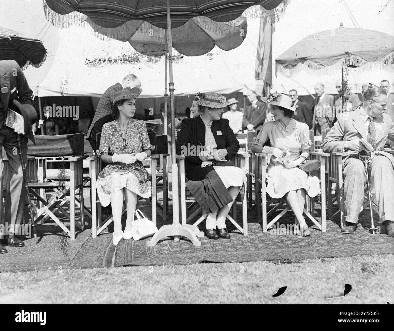 The Royal Windsor Horse Show is being held once again this year and opened with a large number of entries for the events today, and will continue until Saturday. Among those who attended today, were Princess Elizabeth and Margaret and the Duchess of Beaufort. Picture shows: Pictured at Windsor, watching the show of Princess Elizabeth (left) and Duchess of Beaufort (centre) and Princess Margaret.  26 June 1947 Stock Photo