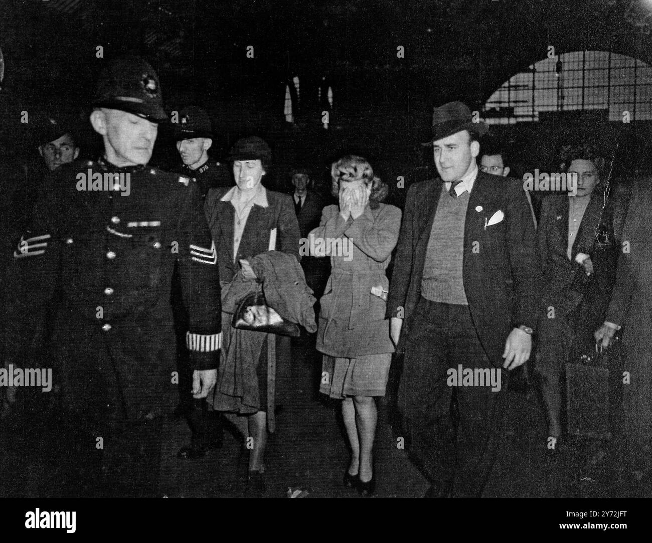 Doris Hart (In centre at back of car) is driven away from King's Cross station after arriving from Goole tonight. She's in London to help Scotland Yard detectives in their investigation into the De Antiquis shooting.  17 May 1947 Stock Photo