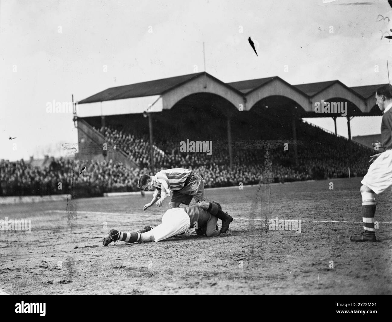 Charlton were playing at home to Brentford at the Valley today. Picture shows:  Bartram, Charlton's goalkeeper, goes out to save from Blakeman, Brentford forward, as Phipps Charlton centre half, guards the past to the goal, at today's match at the Valley.  22 March 1947 Stock Photo