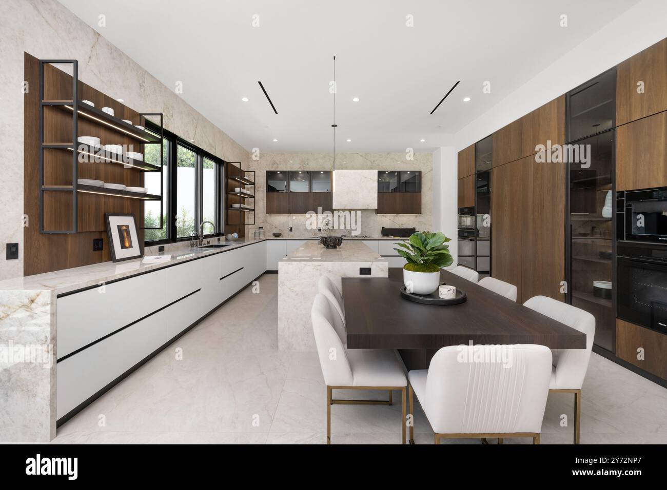 Modern kitchen with sleek cabinetry, marble countertops, and a dining ...
