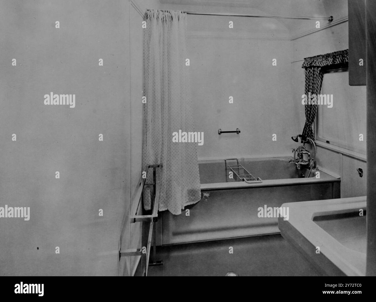 Eight of the 14 coaches which will comprise the 'White Train', to be used by their majesties and the Princess during their tour of South Africa next year, have been completed at the Metro-Cammell works at Birmingham. Five of these coaches are saloons of special designed to accommodate the King and Queen, the princesses, Royal household staff, and South African Government Ministers and staff. The coaches are fully air-conditioned, fitted throughout with safety glass, and will afford almost silent travel. Picture shows: his Majesty's bathroom in the Royal train. The walls are finished in cream, Stock Photo