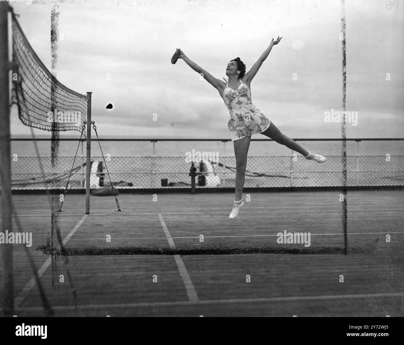 Passengers on the maiden voyage of the RMS 'Queen Elizabeth' a luxury liner, enjoyed deck sports during the Atlantic crossing. The sports deck extends the whole width of the great ship.   Picture shows some of the guests enjoying a game of quoits  aboard the Queen Elizabeth.   23 October 1946 Stock Photo