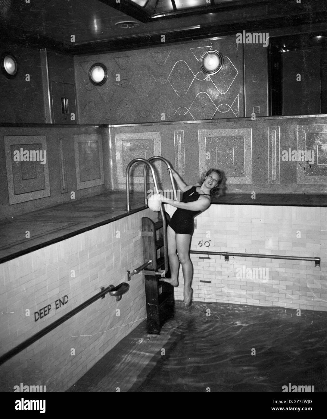 Passengers on the maiden voyage of the RMS 'Queen Elizabeth' a luxury liner, enjoyed deck sports during the Atlantic crossing. The sports deck extends the whole width of the great ship.   Picture shows one of the guests enjoying a swim in the indoor pool aboard the Queen Elizabeth.  23 October 1946 Stock Photo