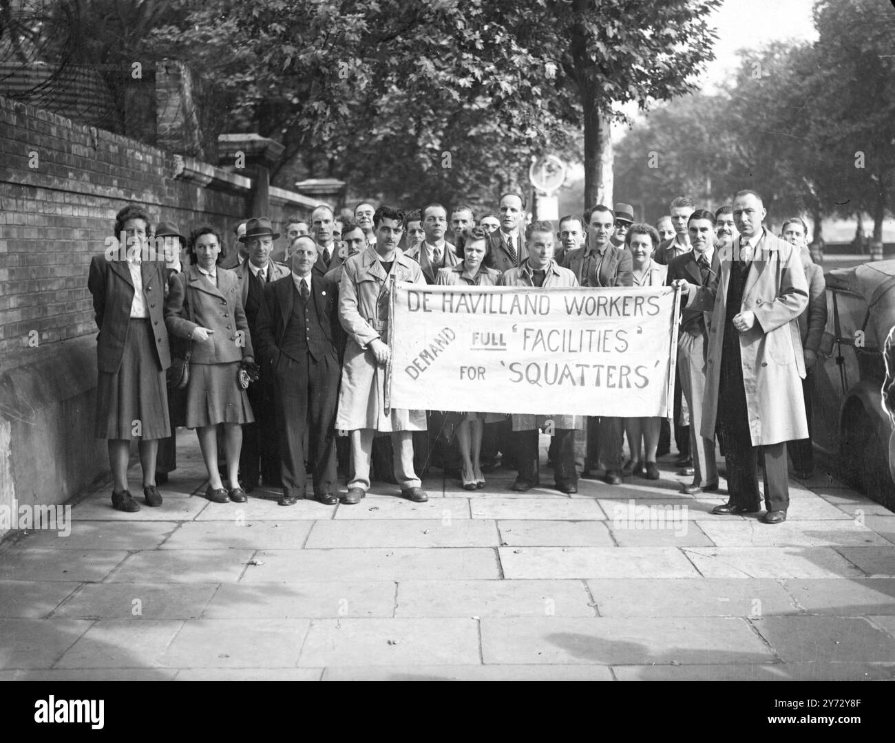 A deputation of aircraft workers supporting the London 'squatters' went to the Ministry of health this morning to present a petition calling for food, water and light to be supplied to the 'squatters' and further requisitioning of properties for homeless people. Picture shows: members of the deputation with their banner seen near the Ministry of health this morning.  17 September 1946 Stock Photo