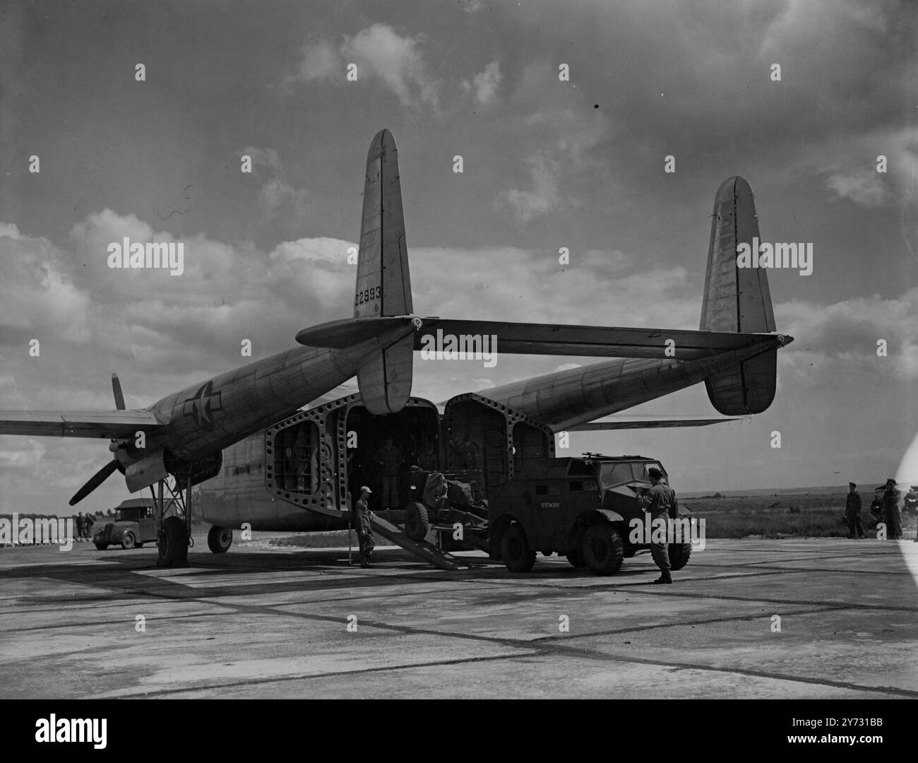 A 'packet' of trouble. The latest American transport for airborne operations. The C82 , Fairchild 'Packet' was demonstrated at Beaulieu, Hants, today, Thursday.  Picture shows, a British 25 pounder gun and 'quad' reversing into the tale of the 'Packet' during today's demonstration.   8 August 1946 Stock Photo