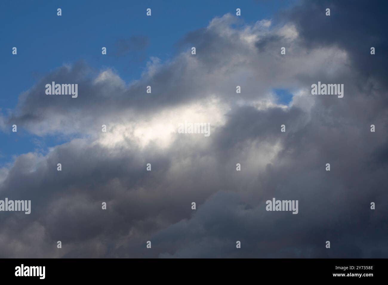 A dramatic sky, colorful sky, before storm and during sunset. Huge clouds formations. Stock Photo