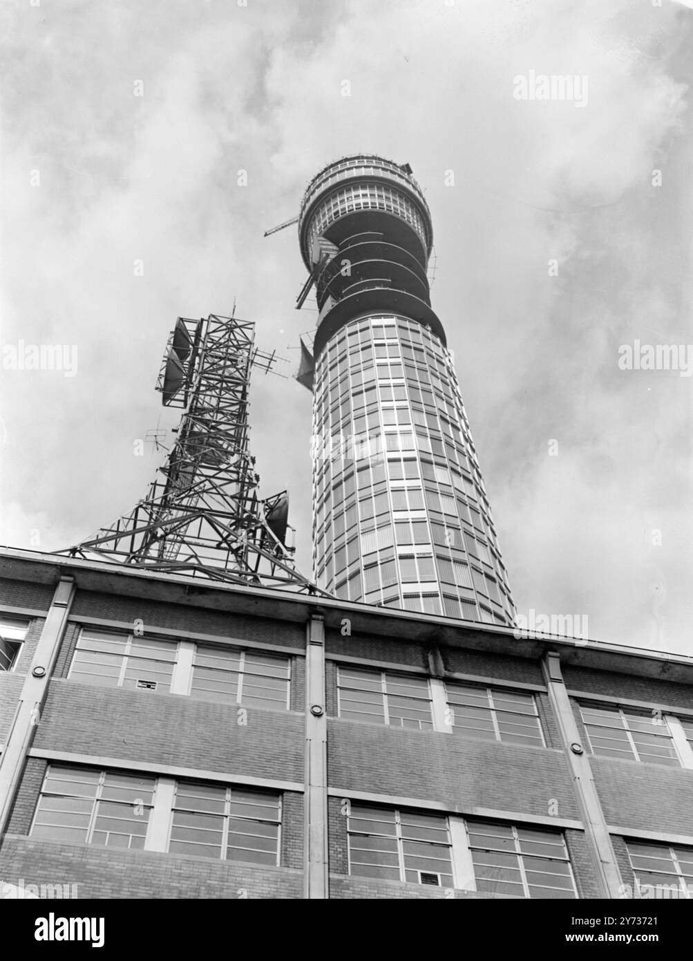 Looming above Tottenham Court Road in London is the nearly completed Post Office TV Radio Tower which was topped out yesterday . The building promises to be a tourist attraction for apart from housing the Museum telephone exchange will have a revolving restaurant at its pinacle . The restaurant however , is not due to serve its first meal until January 1966 . The tower will be Britain's tallest building at the height of 619 feet . 16 July 1964 Stock Photo