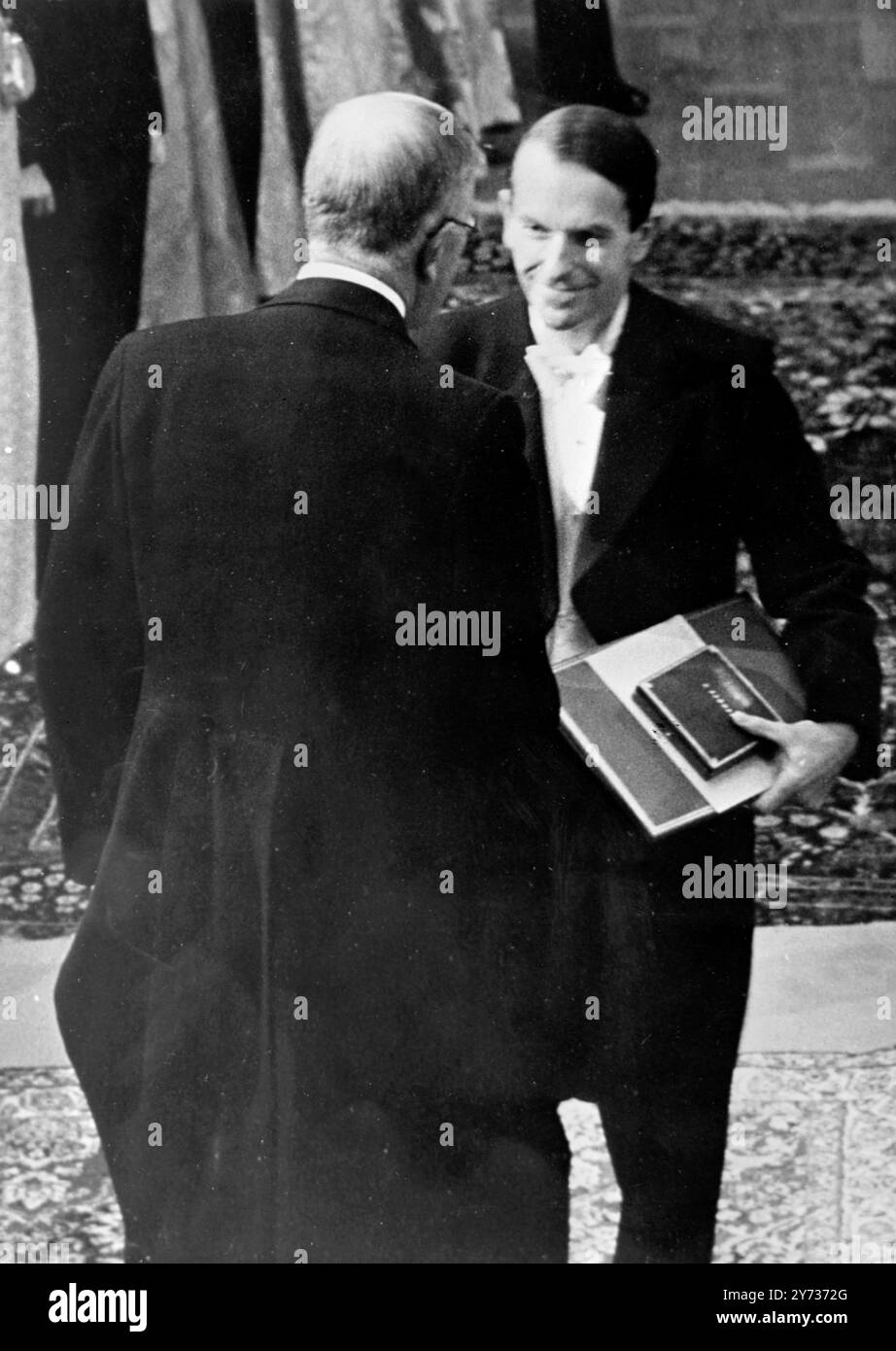 Dr Frederick Sanger , of Cambridge University , receiving his Nobel Prize for Chemistry from  King Gustav Adolf of Sweden (back to camera) in a ceremony  at Stockholm City Concert Hall .  Dr Sanger received the prize for chemistry . 10 December 1958 Stock Photo