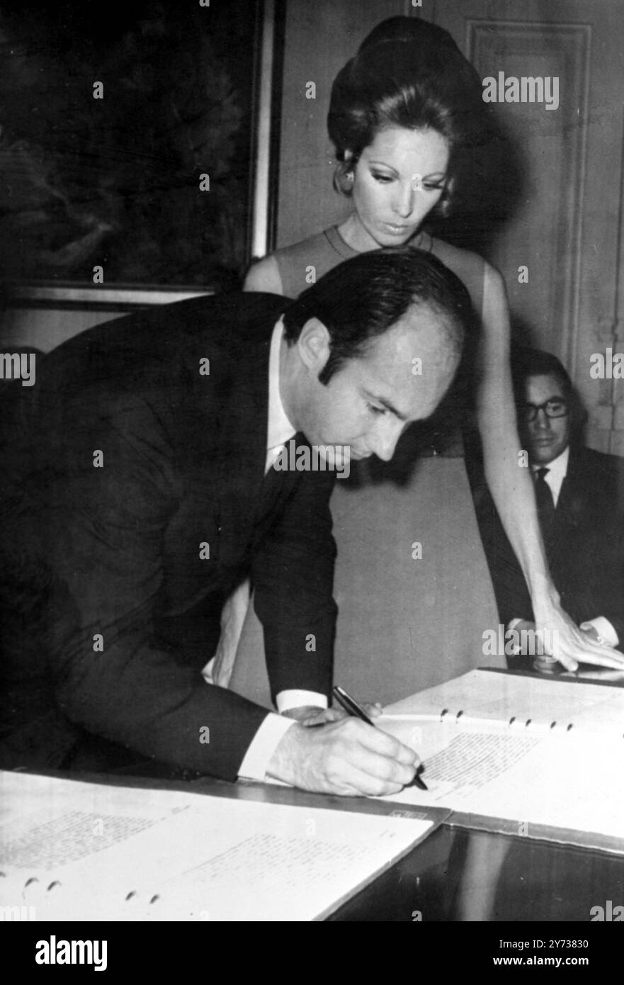 Signing the wedding book . Paris :  Prince karim Aga Khan , spiritual leader of 20 million Ismaili Moslems , signing the wedding book at the Paris ' 4th District Town Hall during his civil wedding to Lady James Crichton - Stuart .  The wedding was conducted by the Mayor of the 4th District , M . Theolierre .  Their religious wedding will take place in the Aga ' s Paris mansion .  The 29 year old bride , who has become a Moslem , is the former wife of the Marquis of Bute .  22 october 1969 Stock Photo