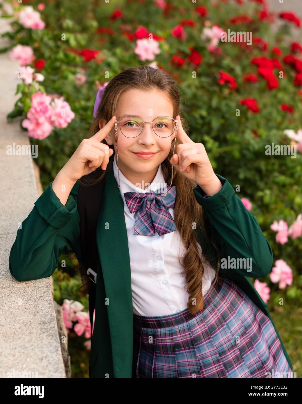 girl-in-a-uniform-with-both-hands-adjusting-glasses-posing-in-front-of