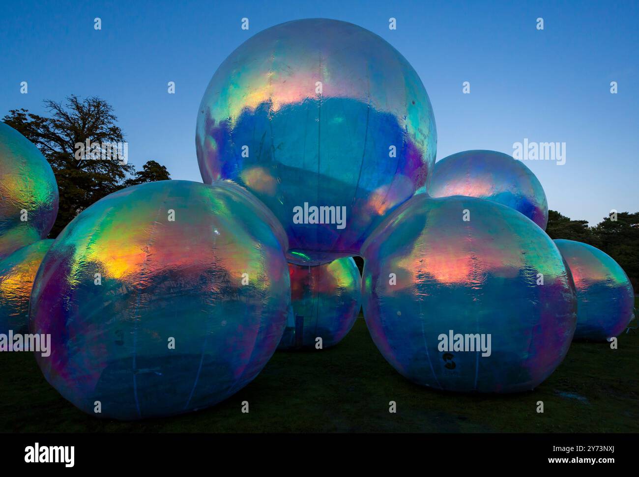 Bournemouth, Dorset, UK. 27th September 2024. Crowds flock to Bournemouth for the Arts by the Sea Festival with the theme of Taste, a fun time with quirky theatre, dance and music, providing spectacular shows and inspirational installations for free family entertainment - the first day of the three day event. Evanescent by Atelier Sisu giant bubble structures illuminated in the Lower Gardens, a playful world of light and colour to get in touch with your inner child and embrace whimsy and wonder exploring the hypnotic and tactile sculptures. Credit: Carolyn Jenkins/Alamy Live News Stock Photo