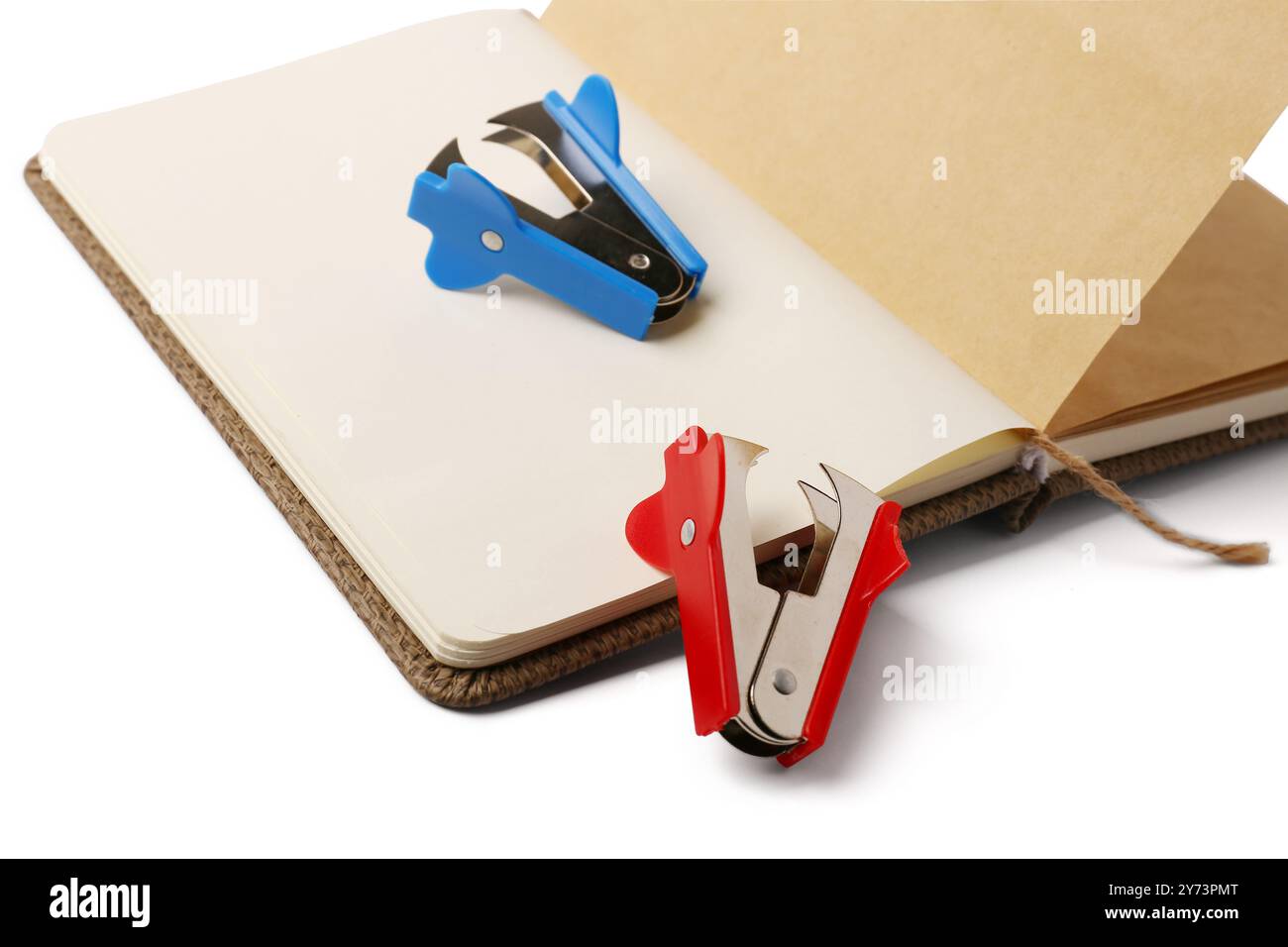 Open notebook and staplers on white background Stock Photo